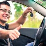 Man Giving Thumbs Up Holding Keys In Car