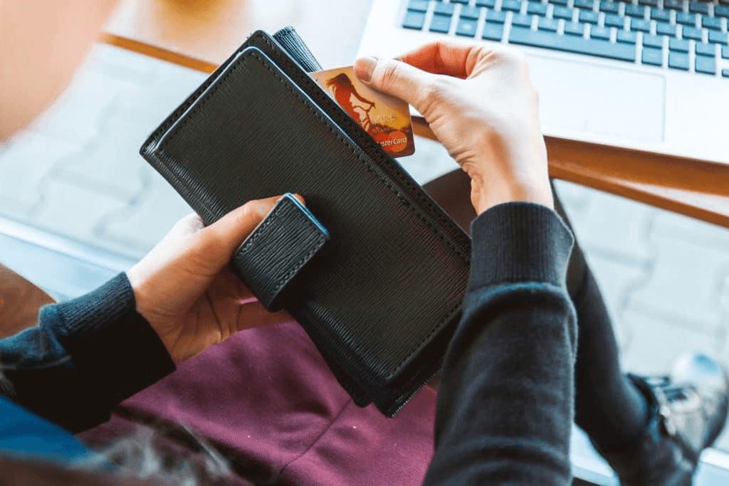 A person putting away their credit card