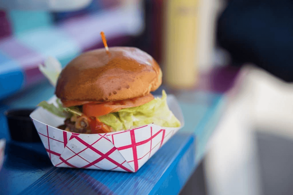 A hamburger on the slab of a food truck