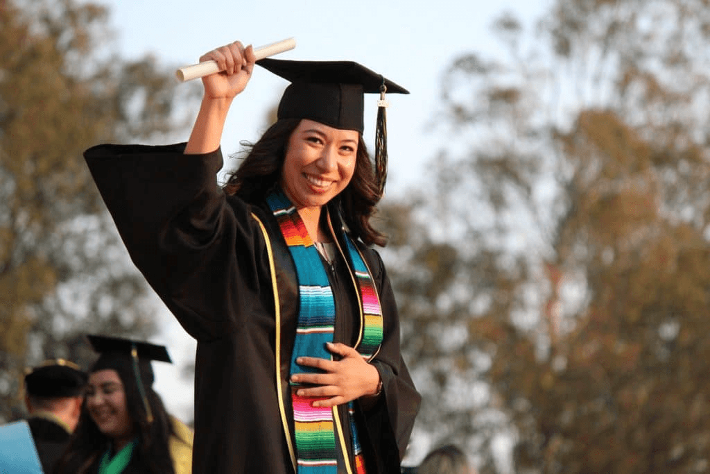 A woman in cap and gown celebrating her graduation