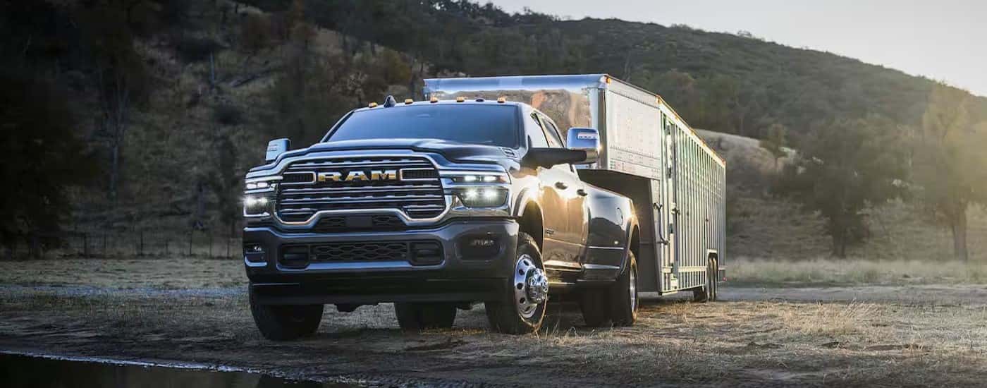 A black 2025 Ram 3500 towing a trailer after visiting a Ram dealer near San Antonio.