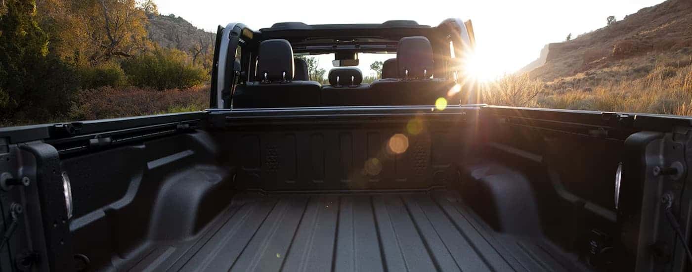 The empty bed of a 2025 Jeep Gladiator at a Jeep dealer.
