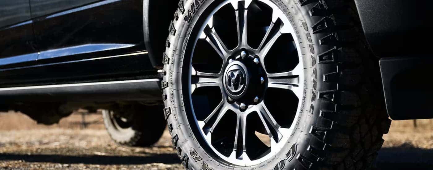 The rim and tire on a black 2025 Ram 2500.