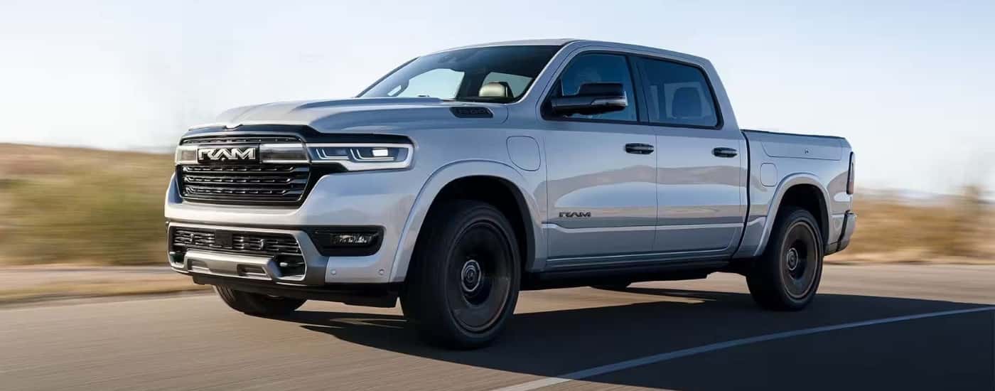 A silver 2025 Ram 1500 Ramcharger driving to a Ram dealer near Helotes.