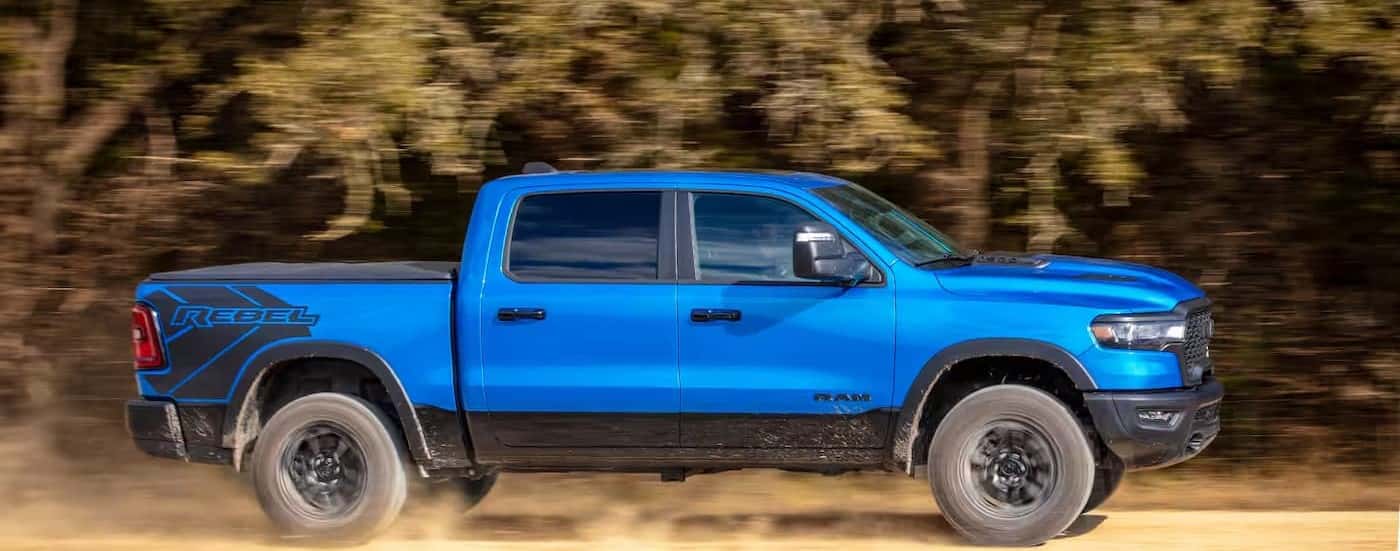 A blue 2025 Ram 1500 Rebel off-roading.