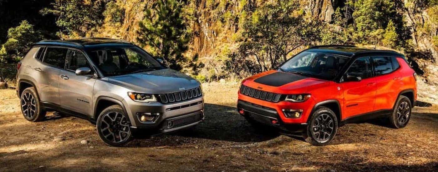 Two Certified Pre-Owned Jeep Compass parked on sandy terrain