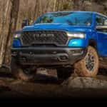 A blue 2026 Ram 1500 parked off-road.