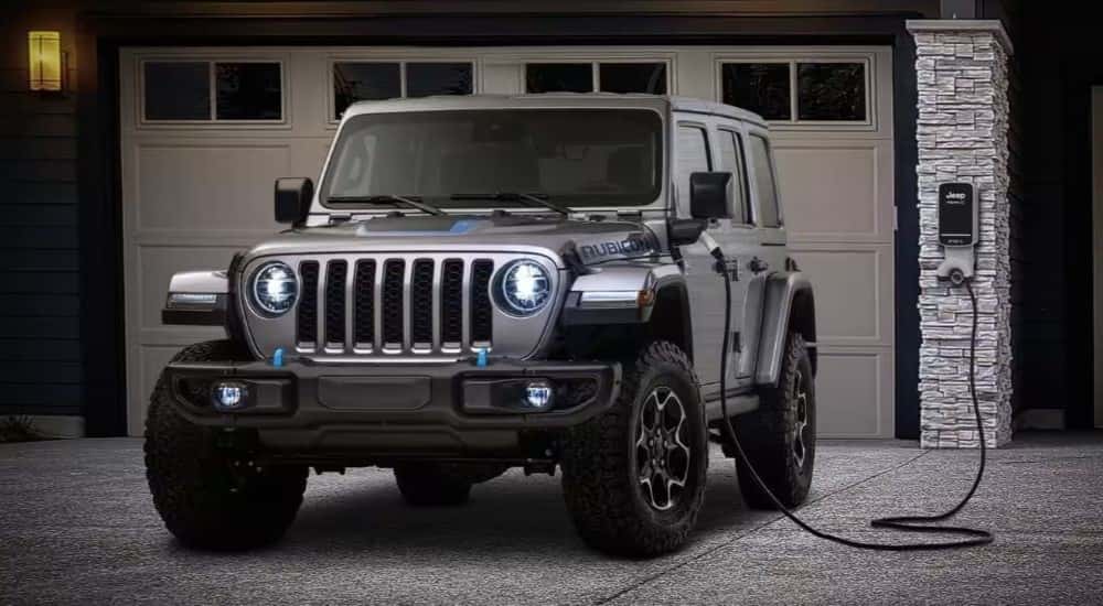 A silver 2025 Jeep Wrangler 4xe Rubicon charging