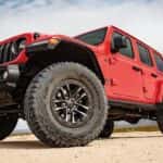 A red 2025 Jeep Wrangler parked off-road