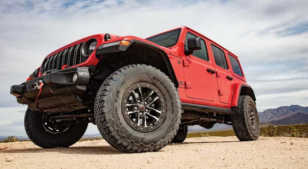 A red 2025 Jeep Wrangler parked off-road