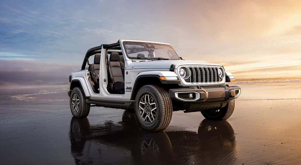A white 2025 Jeep Wrangler parked near water