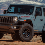 Blue 2025 Jeep Wrangler Rubicon 2-door parked off-road.
