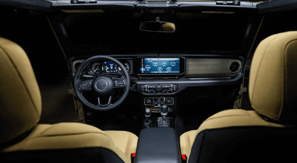 Interior showing steering wheel and infotainment system on a 2025 Jeep Wrangler for sale near San Antonio. 