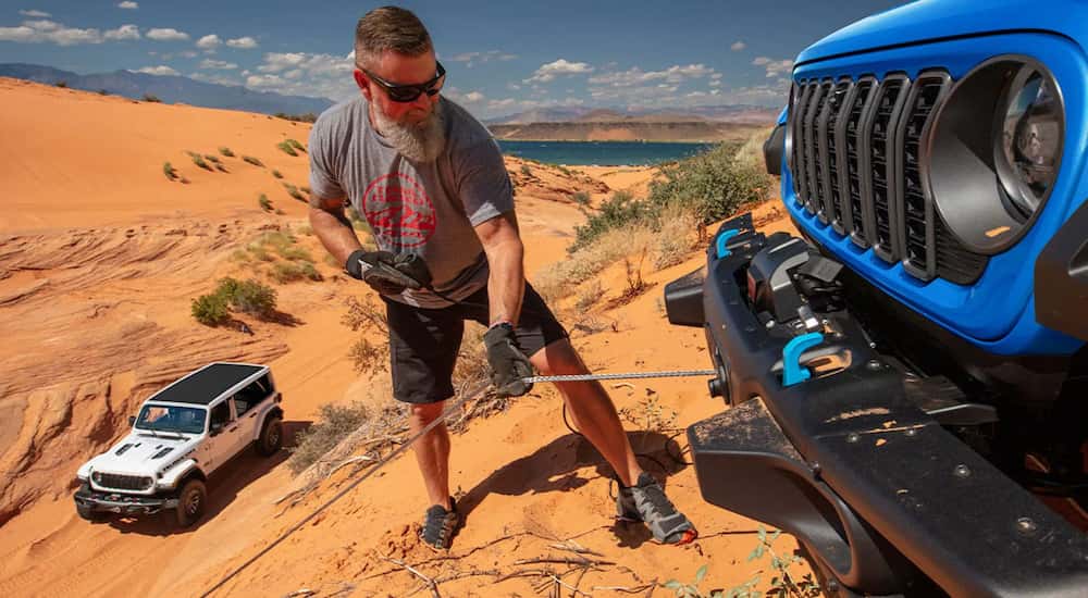 A person demonstrates the winching capabilities of the 2025 Jeep Wrangler.