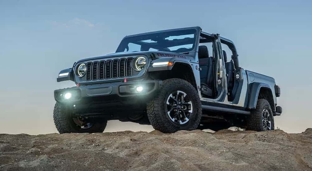 A blue 2026 Jeep Gladiator parked on a hill.