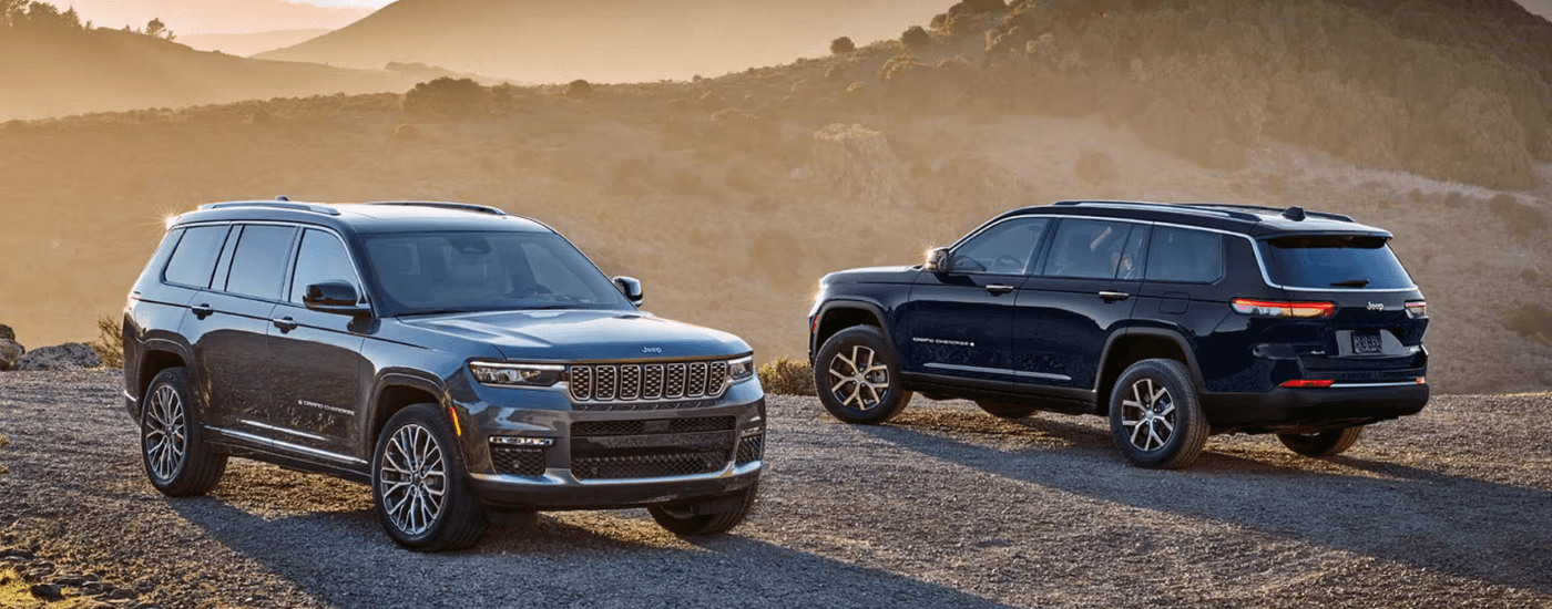 A grey and black Jeep Grand CHerokee's parked side by side