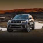A gray 2026 Jeep Grand Cherokee for sale parked near water.