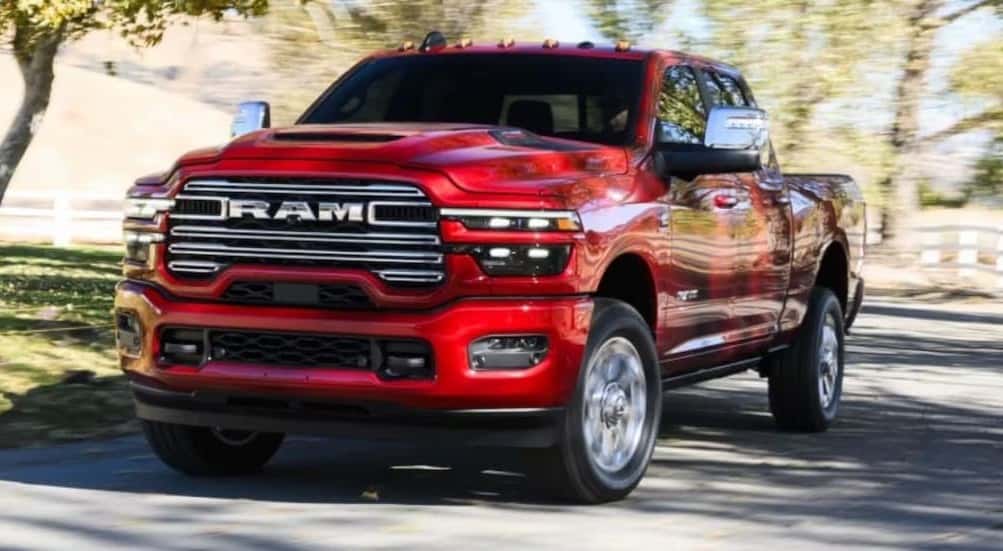 A red 2026 Ram 2500 driving on a road.