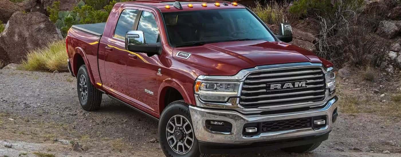 A maroon 2024 Ram 2500 parked off-road for sale