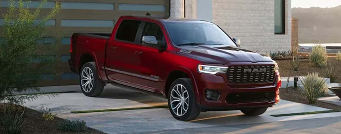 A red 2025 Ram 1500 parked in a driveway