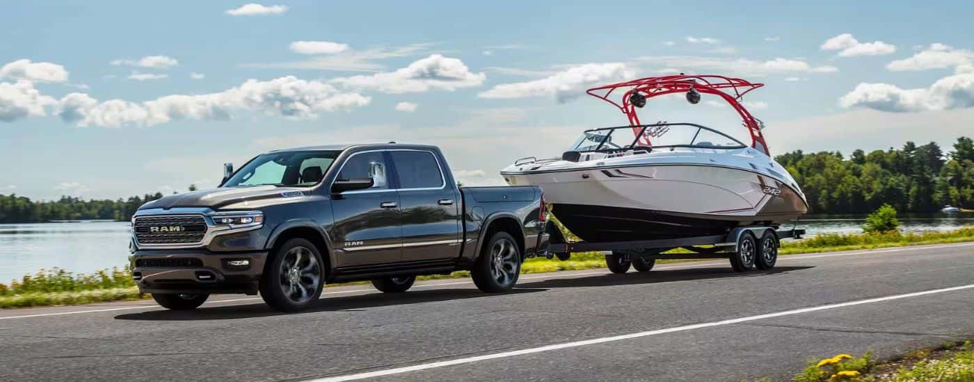 Black 2024 Ram 1500 towing a boat