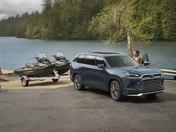 2026 Toyota Grand Highlander towing a boat