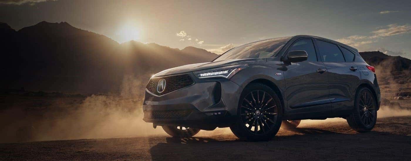 Silver 2024 Acura RDX parked off-road