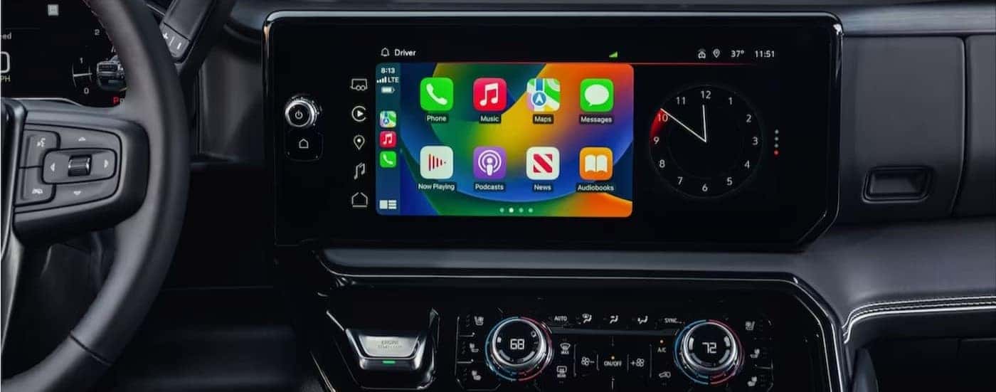 A close-up of the infotainment screen is shown in a 2024 GMC Sierra 3500 HD.
