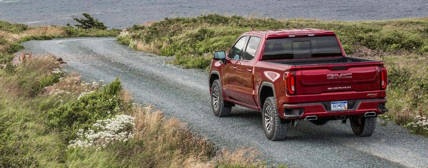 A red 2019 GMC Sierra 1500 AT4 is shown on a gravel path.