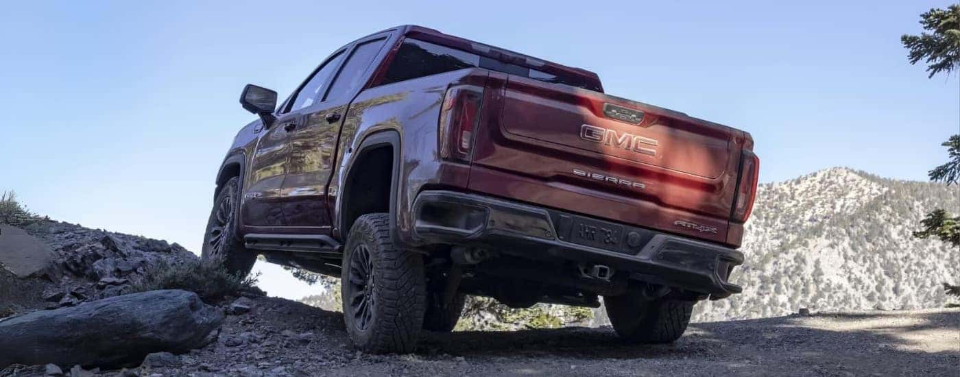A red 2023 GMC Sierra 1500 AT4X is shown off-road after leaving a used car dealer near Winston-Salem.