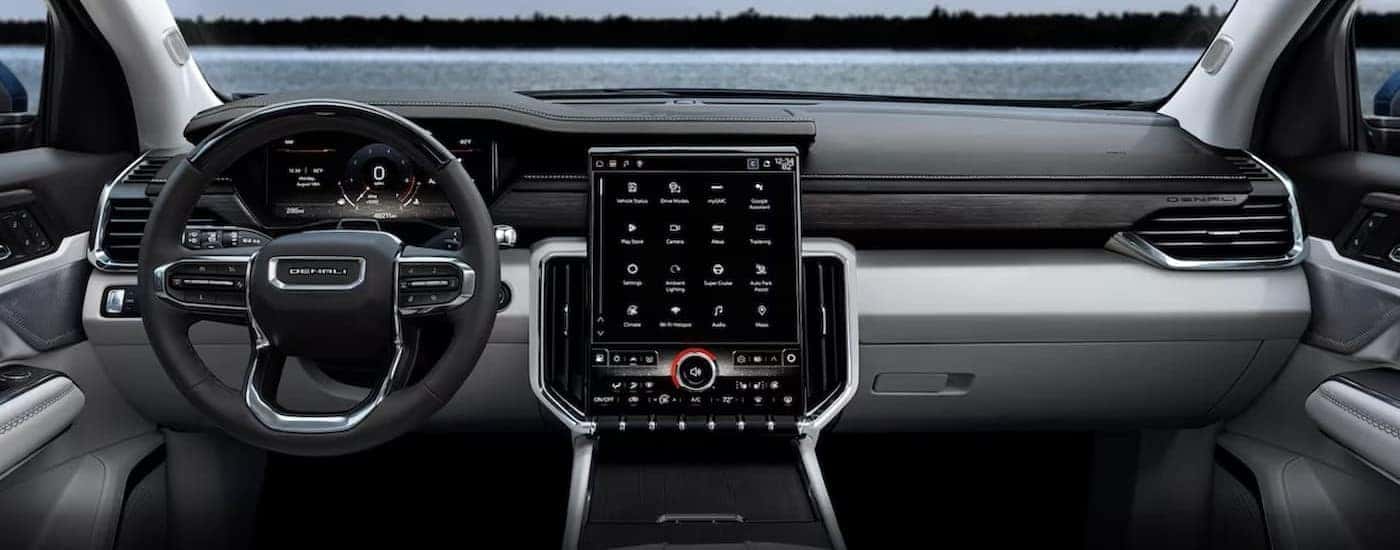 The gray interior and dash are shown in a 2024 GMC Acadia Denali.
