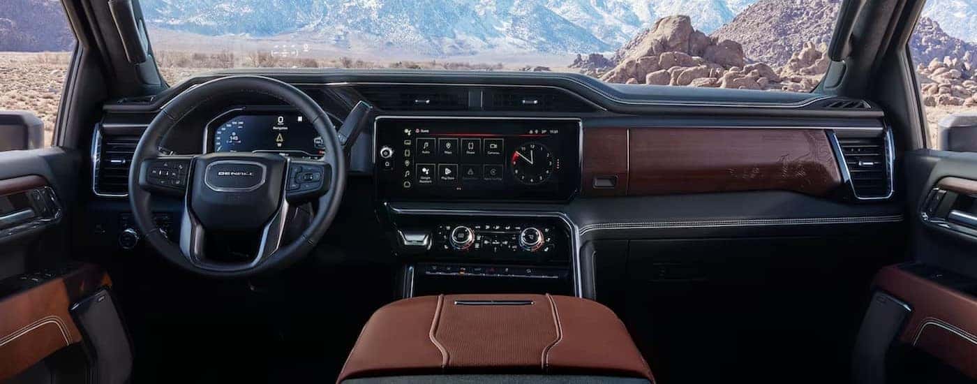 The black and brown interior and dash are shown in a 2025 GMC Sierra 2500 for sale near Greensboro.
