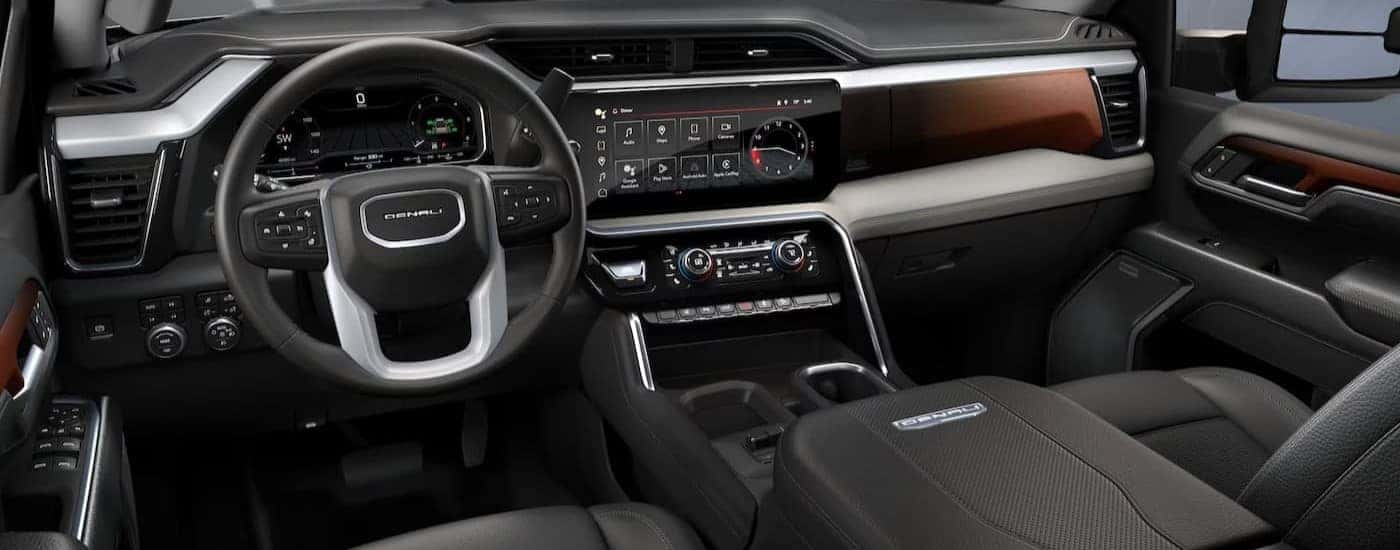 The black and brown interior and dash are shown in a 2024 GMC Sierra 2500 for sale near Greensboro.