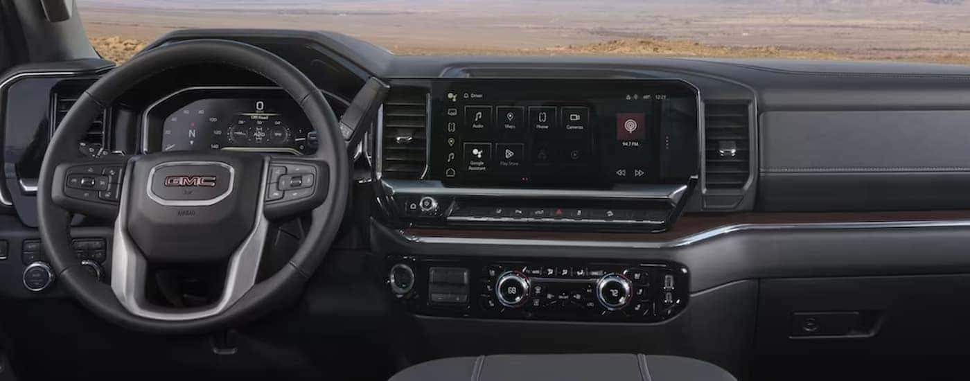 The black interior and dash are shown in a 2024 GMC Sierra 2500 for sale near Winston-Salem.