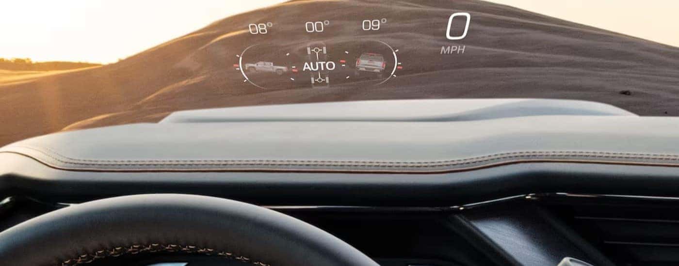 The digital dash display is shown projected onto the windshield of a 2025 GMC Sierra 2500 for sale in Kernersville.