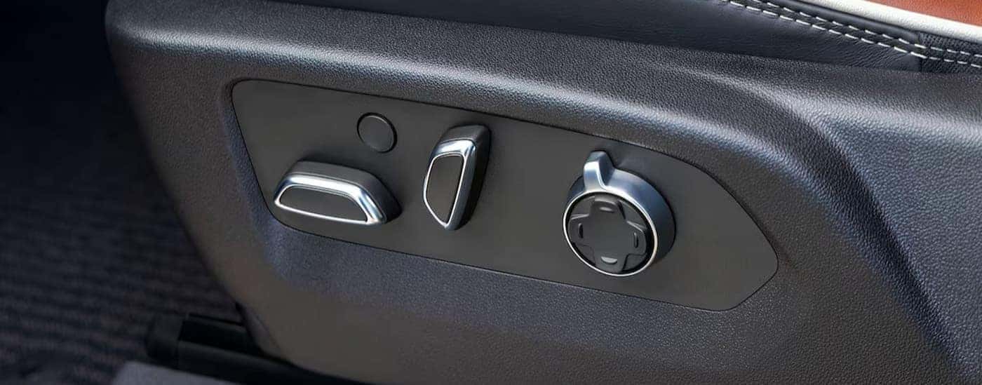 The 16-way power front seat knobs are shown in a 2025 GMC Sierra 2500HD.