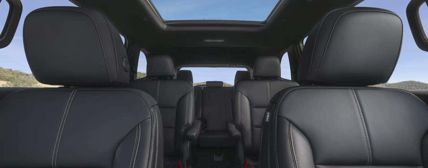 The black rear seating interior is shown in a 2025 GMC Acadia for sale in Kernsville.