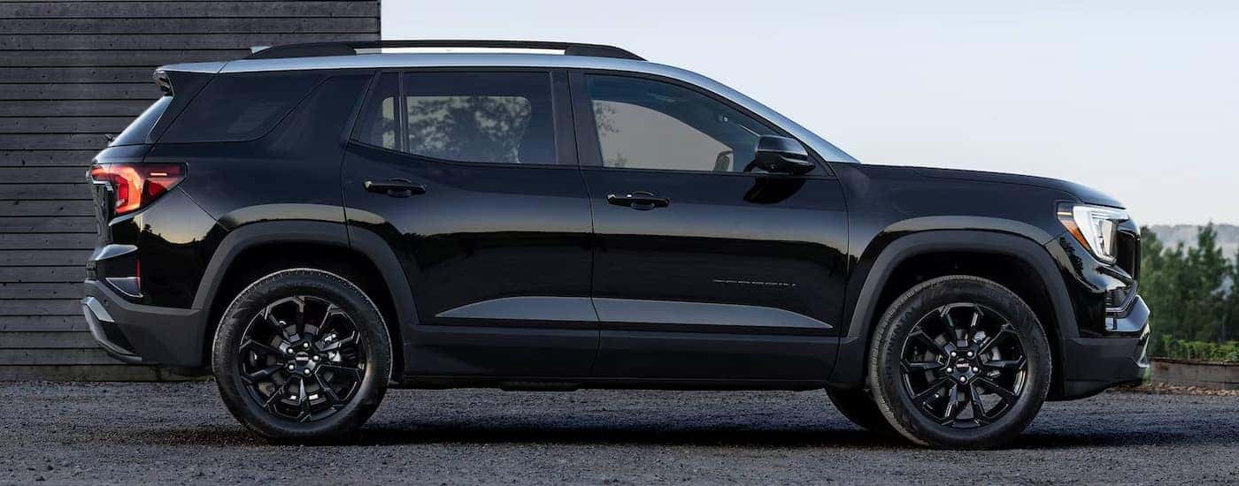 A black 2025 GMC Terrain Elevation for sale parked in a driveway.