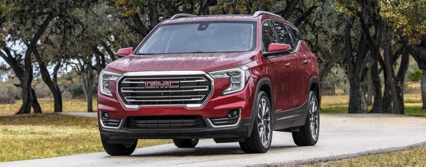 A red 2023 GMC Terrain SLT driving down a trail.