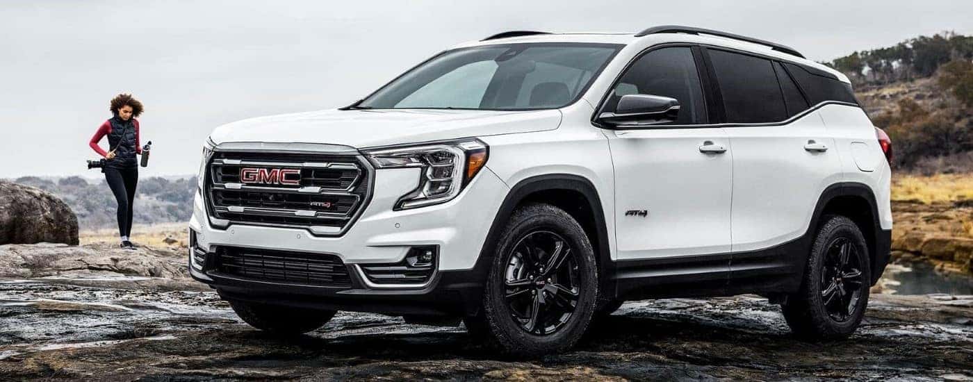 A white 2024 GMC Terrain AT4 for sale in Kernersville parked off-road.