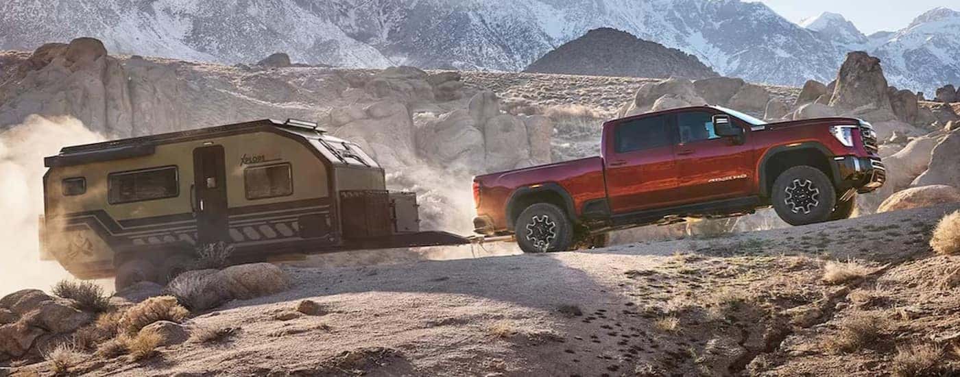 A red GMC Sierra 2500 for sale near Winston-Salem off-roading.