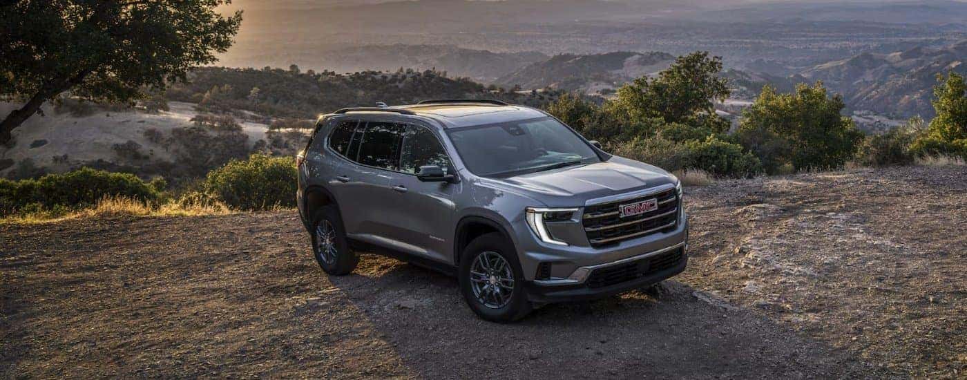 A gray 2025 GMC Acadia Elevation parked off-road