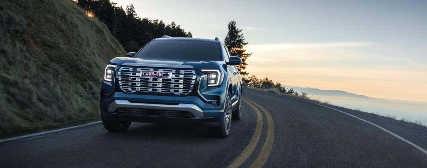 Blue 2026 GMC Terrain for Sale Near High Point driving down the road