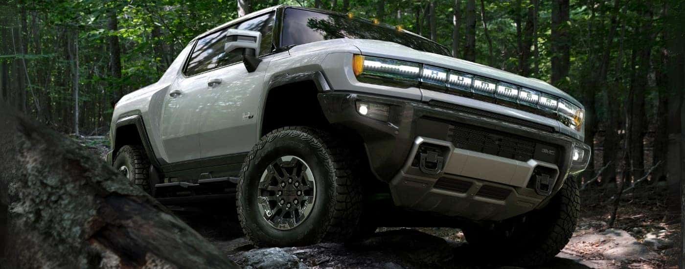 A white 2025 GMC Hummer EV for sale is shown from the front at an angle.