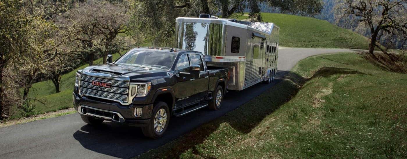 A black 2021 GMC Sierra 2500 for sale near me is towing a trailer.