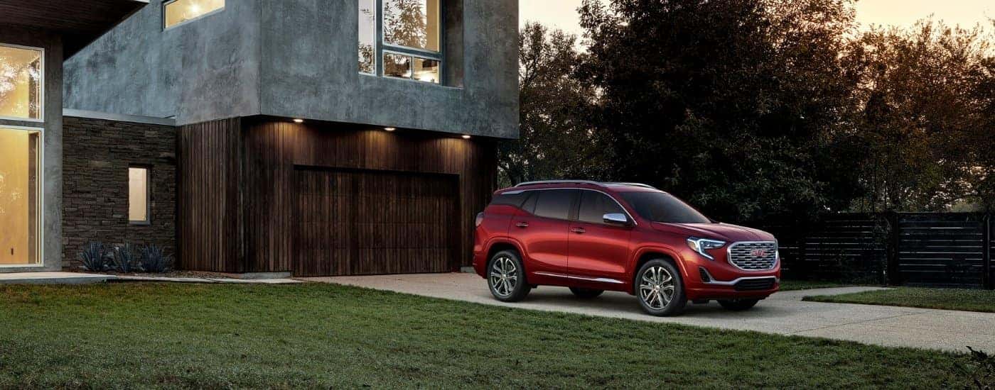 A red 2018 GMC Terrain Denali parked on a driveway.