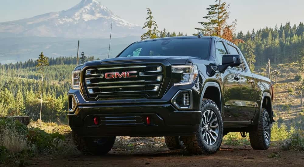 A black used 2019 GMC 1500 for sale parked off-road.