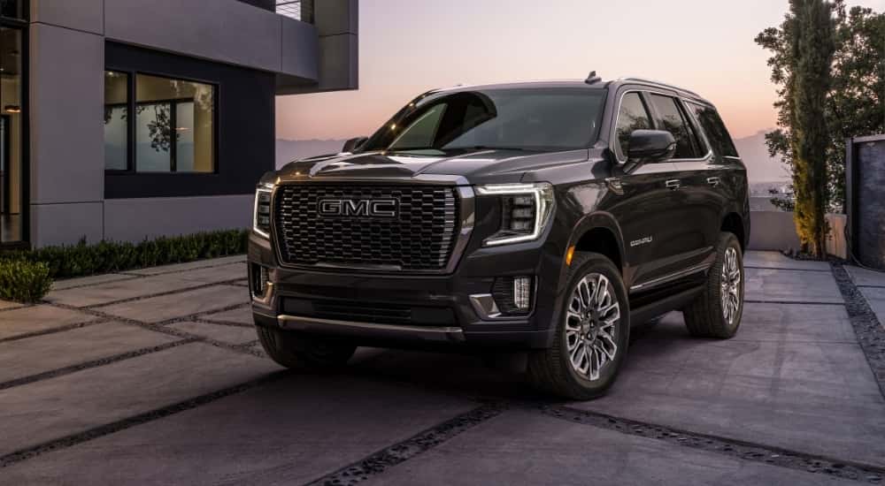 A black 2023 GMC Yukon Denali Ultimate parked on a driveway.