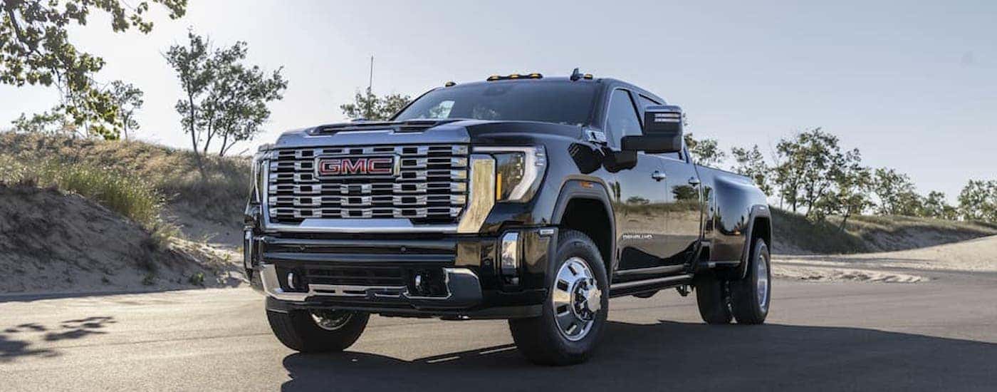 A black 2024 GMC Sierra 3500 Denali from the front at an angle after leaving a dealer that has a used GMC for sale near Winston-Salem.