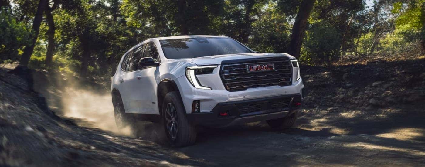 A white used 2024 GMC Acadia AT4 off-roading